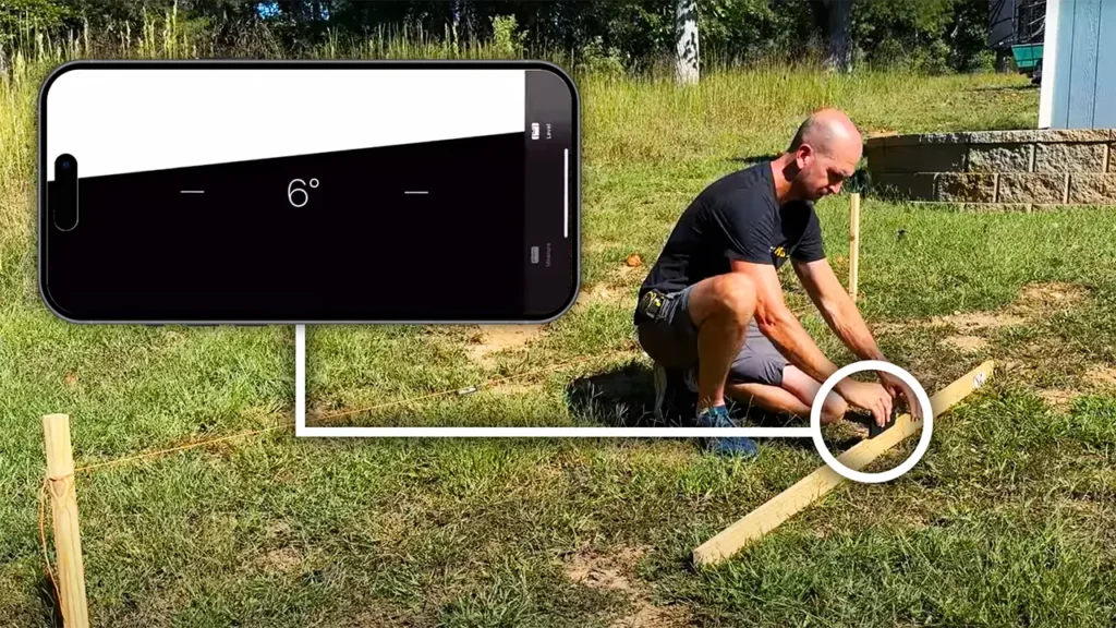 A phone using the Measure app to measure the degree angle for yard slope.